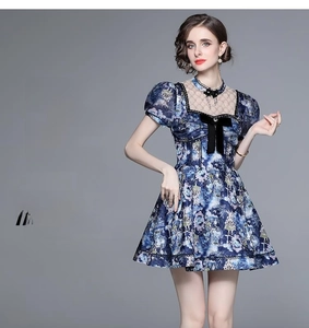 Detail of blue summer dress featuring a velvet bow tie and sheer mesh neckline