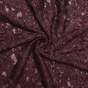 Close-up of elegant burgundy floral lace fabric with detailed mesh and intricate texture