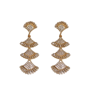 Gold-plated layered fan tassel earrings with sparkling zircon crystals on white background