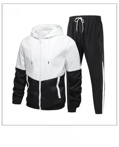 Side view of men's hooded tracksuit with black and white splicing and striped joggers