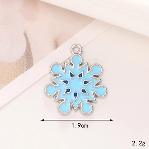 Macro view of blue enamel snowflake pendant showing 1.9cm width and alloy details