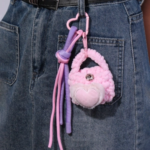 Pink heart plush pouch charm with woven paracord and wings shown on jeans waistline