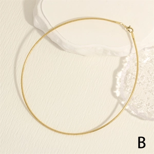 Detail of 18K gold-plated snake chain necklace with lobster clasp on marble stone base