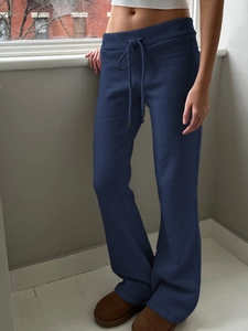 Detail view of navy blue straight wide-leg yoga pants with drawstring waist design