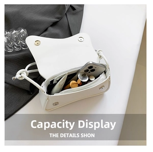 Interior view of white flap crossbody bag showing compartments and magnetic buckles