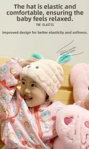 Close-up of pink coral fleece hair towel featuring rabbit ears and high elastic fabric