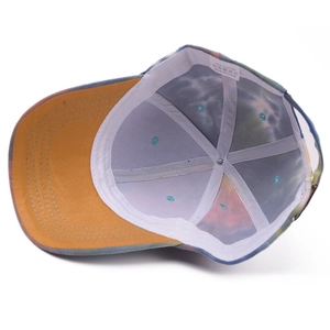 Internal view of a tie-dye cotton baseball cap with yellow brim and reinforced stitching
