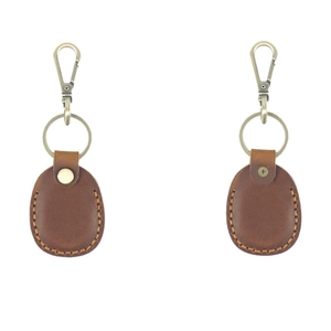 Brown leather Airtag keychain case with metal clasp and visible stitching on white background