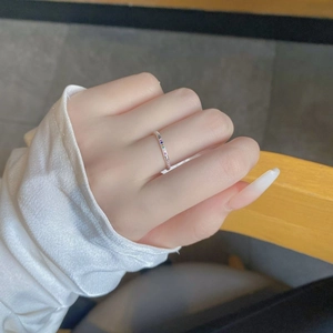 Close-up of a slim S925 silver ring with colorful rainbow cubic zirconia on a finger