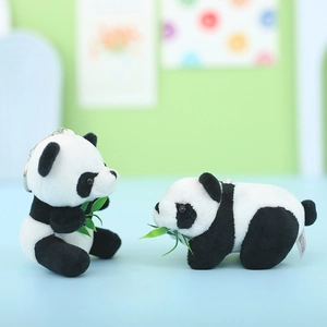Plush panda keychains with green bamboo leaves in sitting and crawling poses