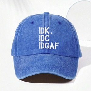 Close-up of white embroidered IDK IDC IDGAF text on a blue washed denim baseball cap
