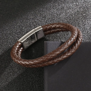 Detail of double-layer dark brown braided leather bracelet with polished magnetic clasp