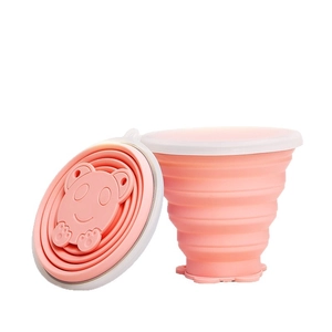 Pink portable collapsible silicone travel cup with cute cartoon bear and white lid