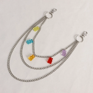 Detail of silver multi-layer metal pants chain with colorful resin bear charms