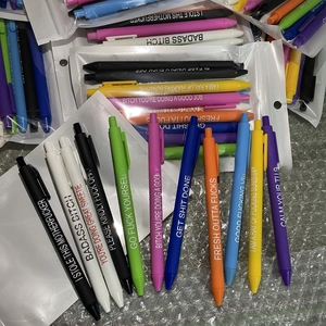 Detail of colorful retractable pens with humorous phrases on silver bubble wrap