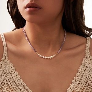 Elegant natural stone necklace with purple beads and white pearls on a model