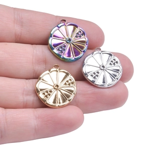 Detailed view of three metallic fruit slice pendants in gold, silver and rainbow colors