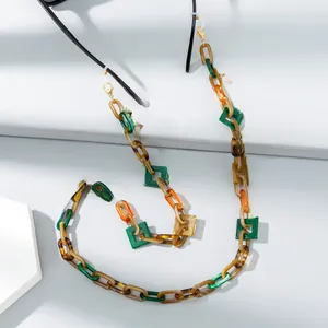 Detail of colorful acrylic glasses chain with green amber and orange geometric links