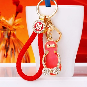 Close-up of heart flip-flop keychain with rhinestones and lucky red braided rope