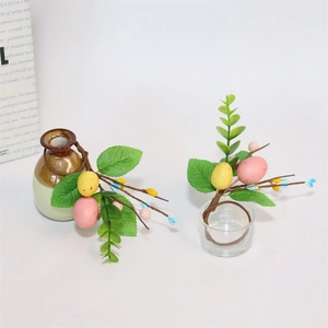 Close-up of Easter egg napkin ring with artificial eucalyptus leaves and colorful speckled eggs