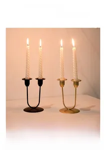 Modern U-shaped metal candle holder with elegant white spiral candles and matte finish