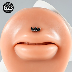 Detailed close-up of G23 titanium labret stud with three black marquise zircons