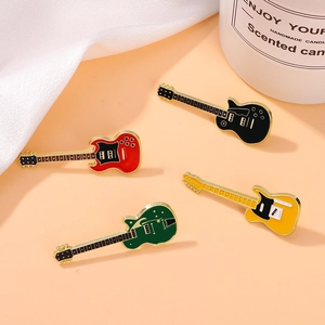 Set of four colorful electric guitar enamel brooches in red, black, yellow, and green