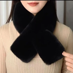 Detailed view of plush black faux mink fur scarf texture on a model wearing a beige sweater