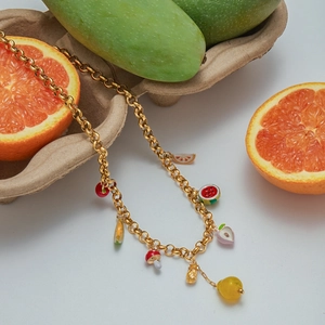 Gold chain bracelet with colorful enamel fruit charms like cherry and pineapple