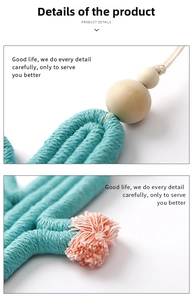 Detail of handmade woven cactus keychain featuring turquoise cotton rope and wood beads