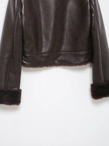 Close-up of faux leather texture and plush trim on deep brown vintage fur jacket