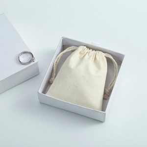 Minimalist white paper jewelry drawer box with cream drawstring canvas storage bag