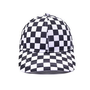 Detailed close-up of a classic black and white checkerboard canvas baseball cap crown
