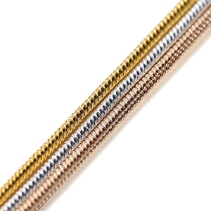 Close-up of snake chains in gold, silver, and rose gold showing fine metal texture