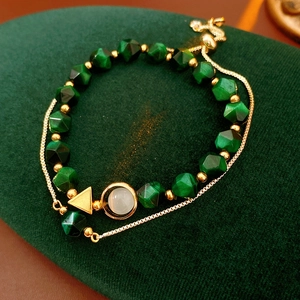 Detail of green tiger eye beads and gold metal accents on a luxury beaded bracelet