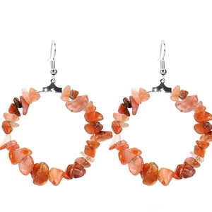 Detail of bohemian hoop earrings with irregular orange natural stone beads on silver hooks