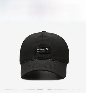 Front view of black breathable baseball cap showing mesh fabric and brand woven label