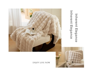 Detail of luxury cream faux rabbit fur blanket with 3D bubble texture and soft plush pillow