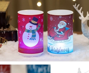 Detail of Christmas LED candle lights featuring snowman and Santa Claus festive patterns