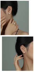 Model wearing silver geometric triangle earrings and ring set with clear cubic zirconia