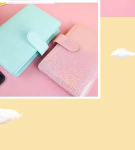 Detail of A6 binder covers in mint green leather and glitter pink with snap closure