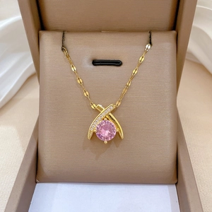 Detail of cross waterdrop necklace with pink zircon pendant in jewelry gift box