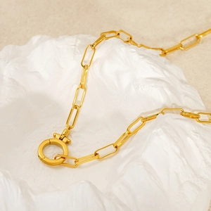 Detailed close-up of gold paperclip chain link necklace with stylish round toggle clasp