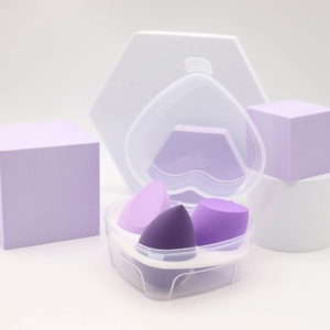 Detail of purple makeup sponge set with teardrop and slant shapes in clear heart box