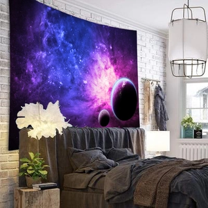 Detail view of the galaxy wall tapestry featuring purple and blue nebulae in a cozy bedroom
