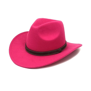 Detail of rose red felt cowboy hat with dark brown band and vintage metal disc ornament