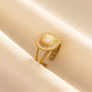 Detail of vintage 18k gold plated stainless steel sunburst ring with twisted band