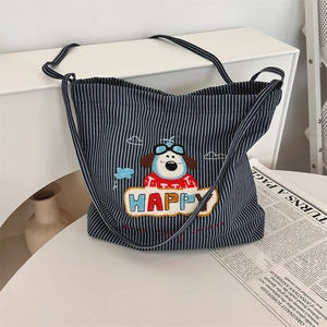 Close-up of cartoon puppy embroidery and HAPPY text on striped canvas tote bag
