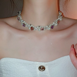 Close-up of pearl heart necklace with pink crystals on model neck for aesthetic look