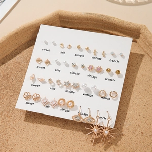 Detail view of 20-pair earring set featuring gold alloy with faux pearls and rhinestones